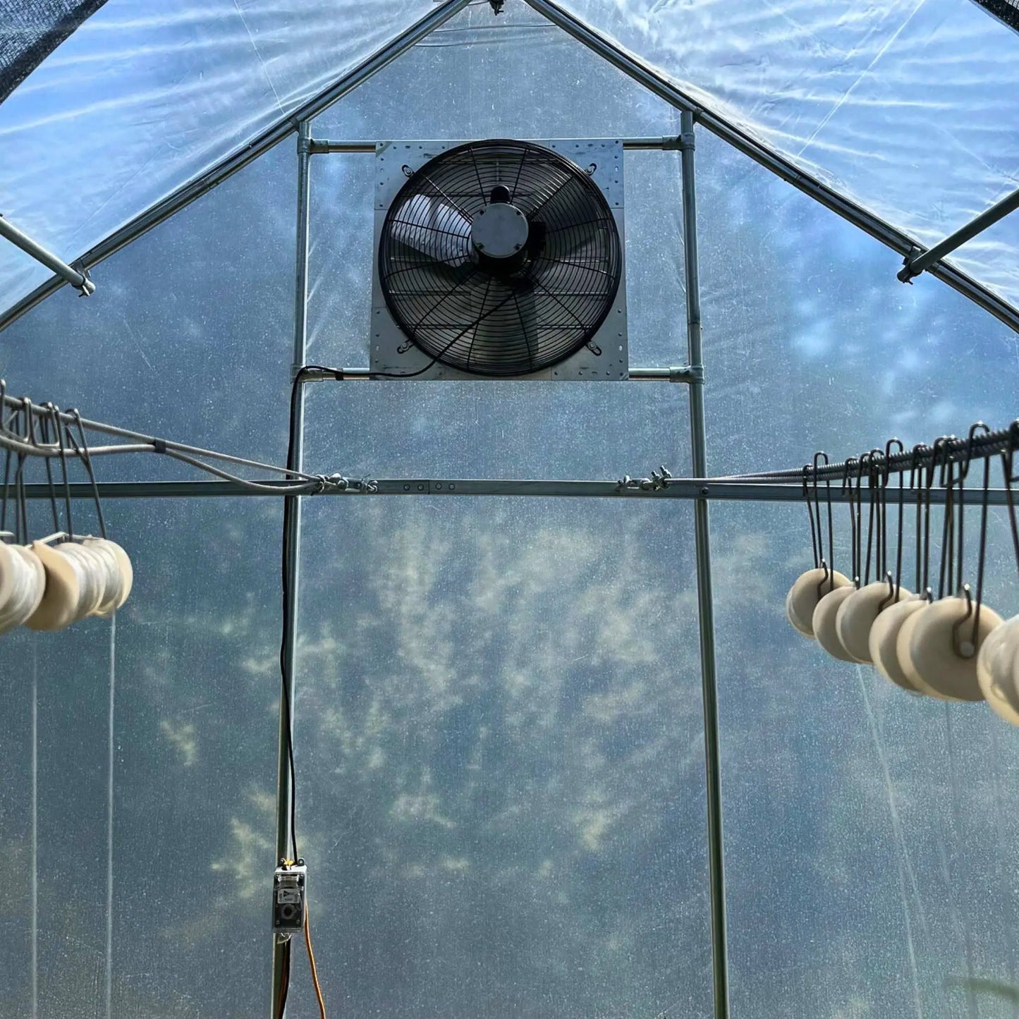 Greenhouse shutter-mount exhaust fan for hoop house by Bootstrap Farmer, black metal housing on Tampa Home & Garden Store