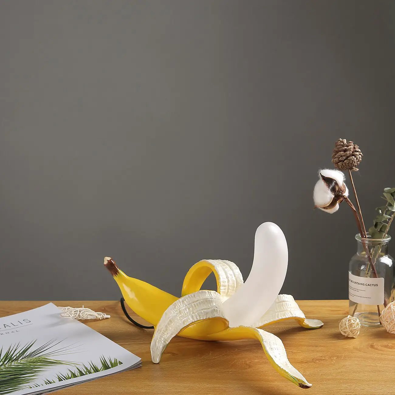 Banana Table Lamp Art Deco brass chrome light with white form beside a banana on a wooden desk on Tampa Home & Garden Store