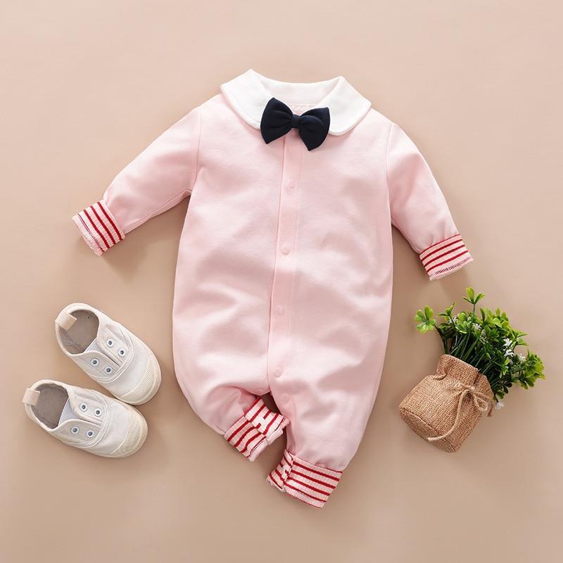 Pink baby romper with white collar and black bow; red striped cuffs; 1 pair white sneakers on Tampa Home & Garden Store