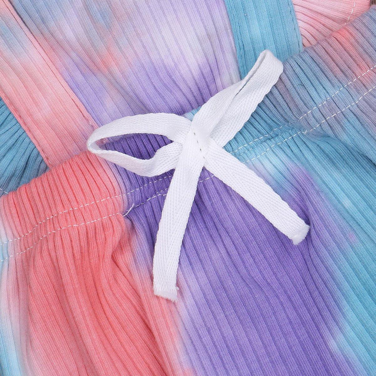 Toddler romper in pastel rainbow print with a white ribbon bow on soft pleated fabric on Tampa Home & Garden Store