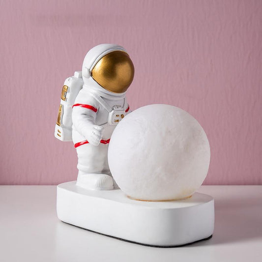 Stevvex astronaut moon night light figurine with white base, gold visor and red accents on Tampa Home & Garden Store