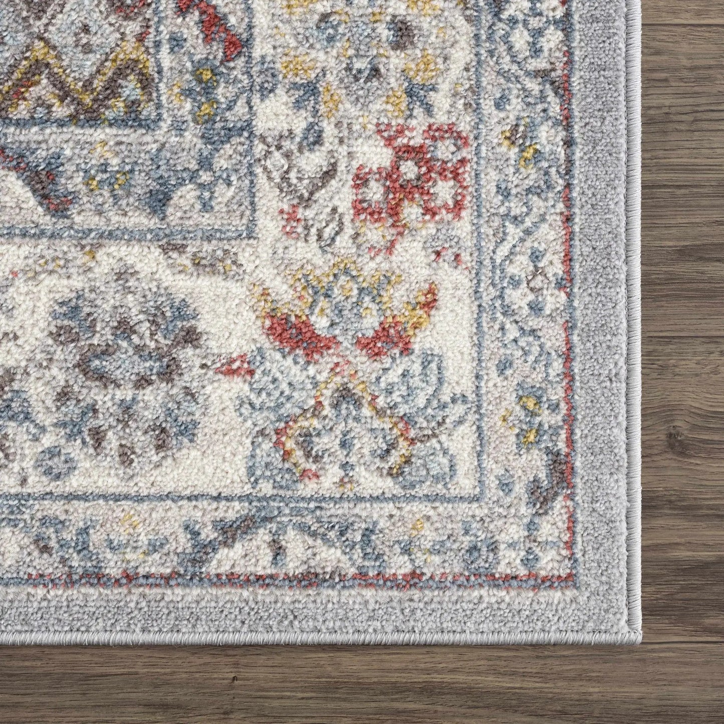 Haymond Area Rug by Boutique Rugs with ivory field and blue, red, yellow floral motifs on Tampa Home & Garden Store