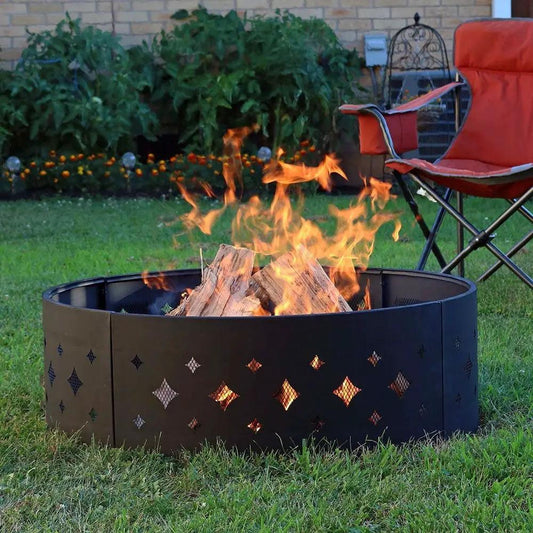 36-inch black steel fire pit ring with diamond cutouts and burning logs in a backyard on Tampa Home & Garden Store