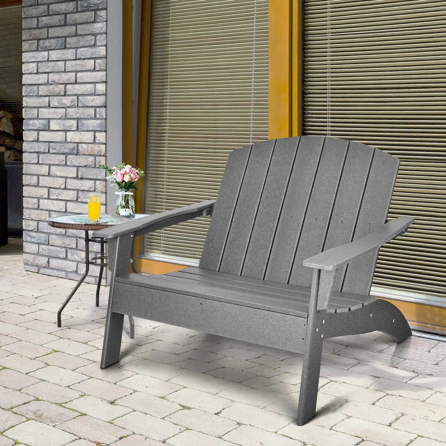 HDPE patio Adirondack chair gray on brick patio with glass-topped table and pink flowers on Tampa Home & Garden Store