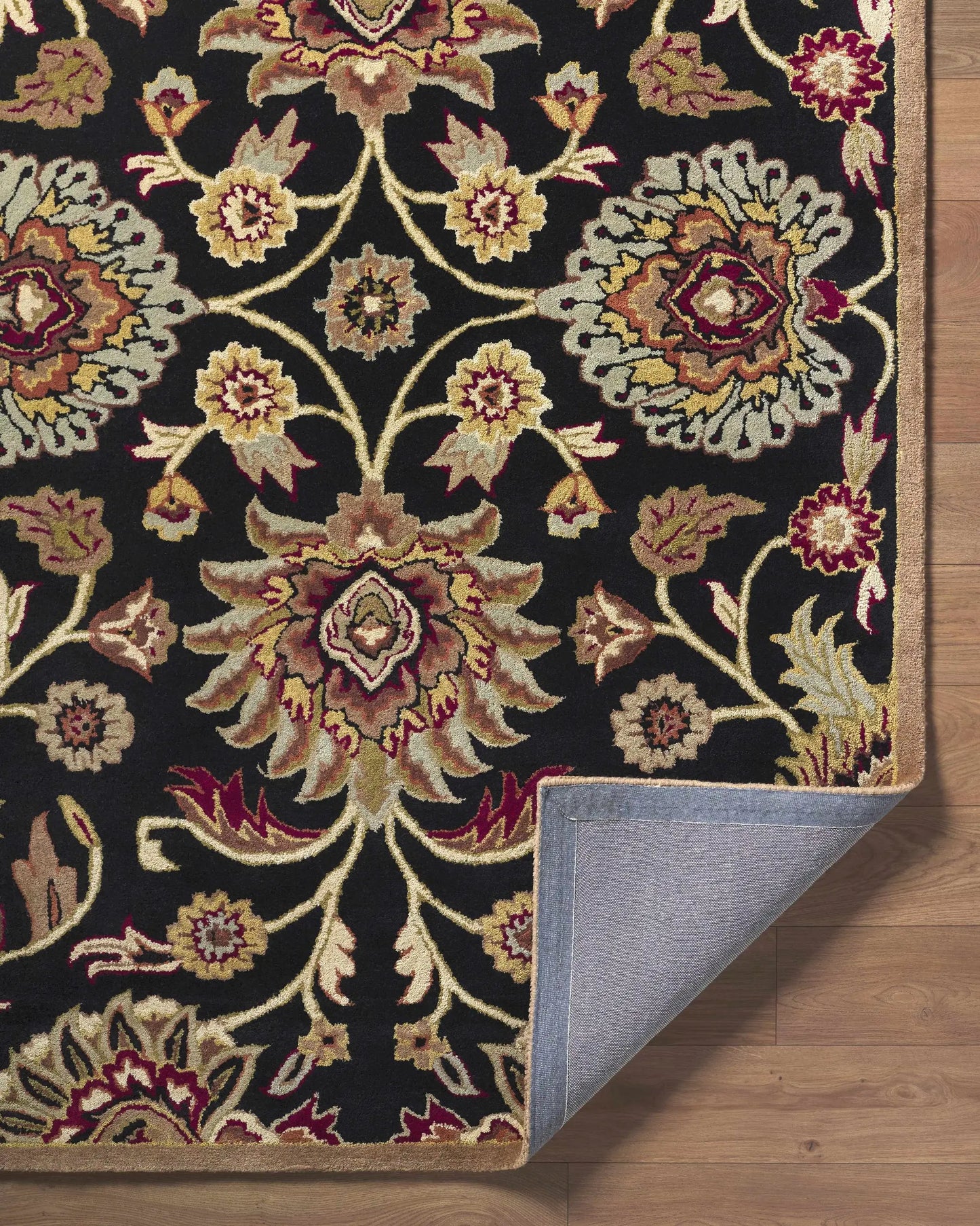 Conesus 1053 hand tufted black wool rug by Boutique Rugs with gold burgundy floral motif on Tampa Home & Garden Store