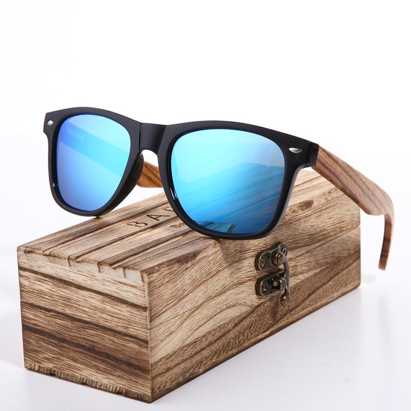 Polarized bamboo sunglasses in zebra wood style with blue mirrored lenses on a wooden box on Tampa Home & Garden Store