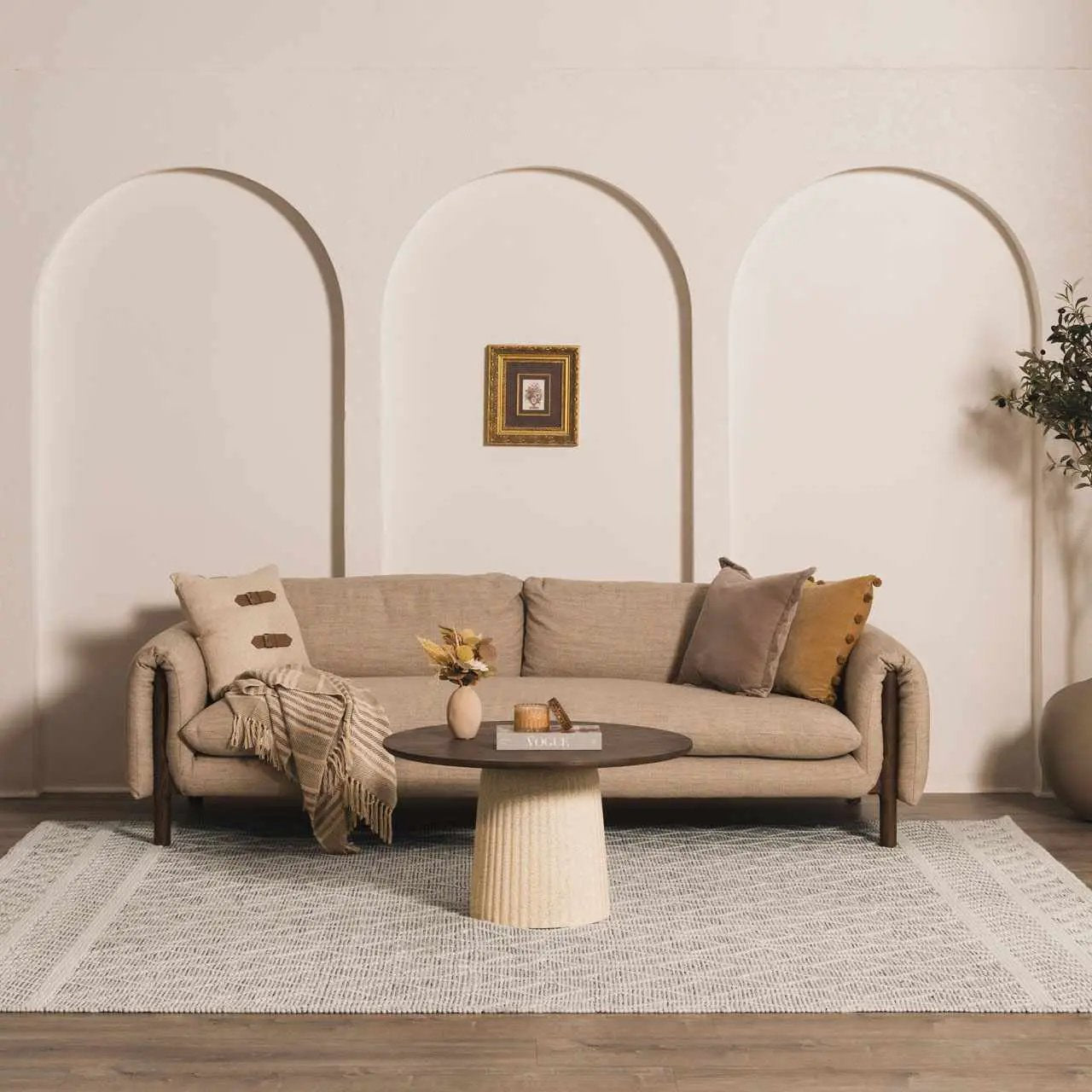 Carolina Wool Area Rug Hand Woven Bohemian Style under a beige sofa in a chic living room on Tampa Home & Garden Store