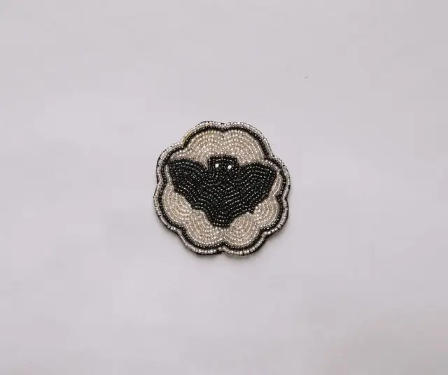 Halloween Bat Beaded Coaster with velvet backing, ivory beaded base and black bat motif on Tampa Home & Garden Store