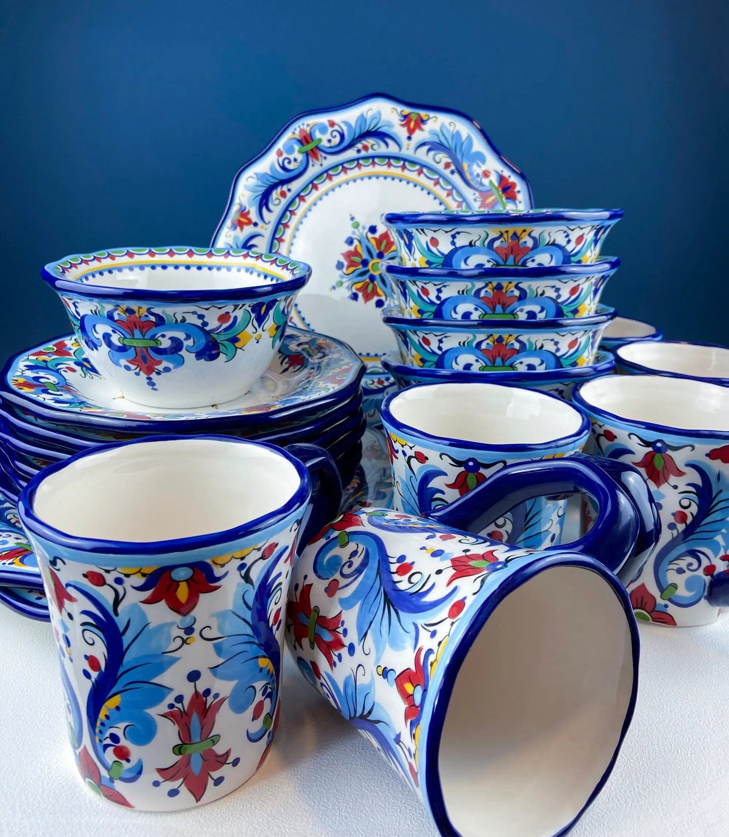 Hand-painted ceramic goblets with blue rims and vibrant floral motifs for wine, water or margarita on Tampa Home & Garden Store