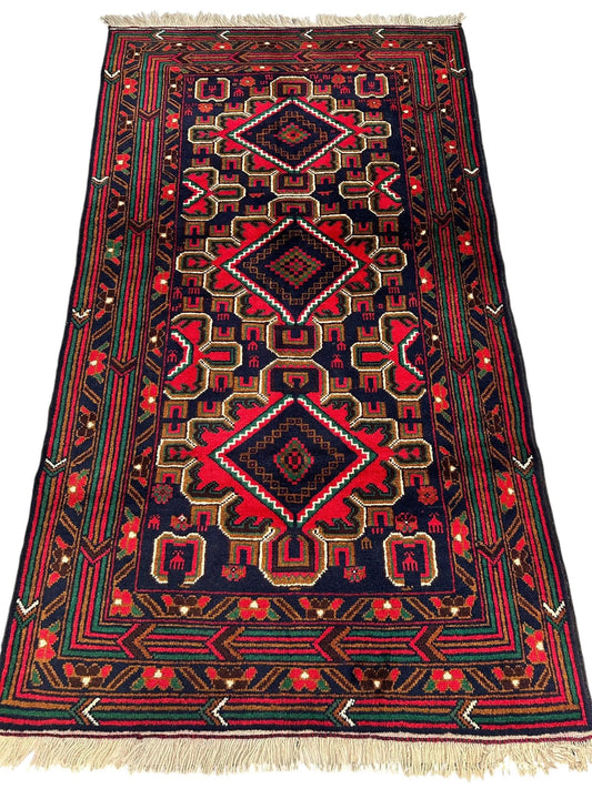Hand knotted Afghani Baluch rug 2ft 10in x 5ft navy red green pattern with fringed ends on Tampa Home & Garden Store
