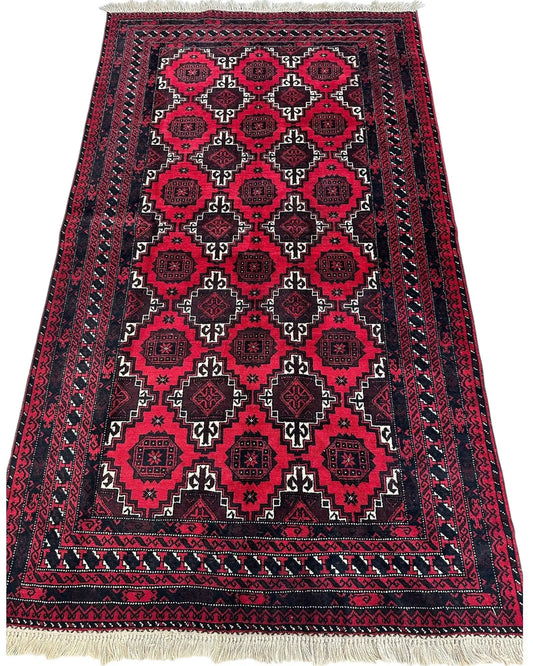 Hand-knotted Baluch Afghan wool rug with vibrant pink field and dark geometric borders on Tampa Home & Garden Store