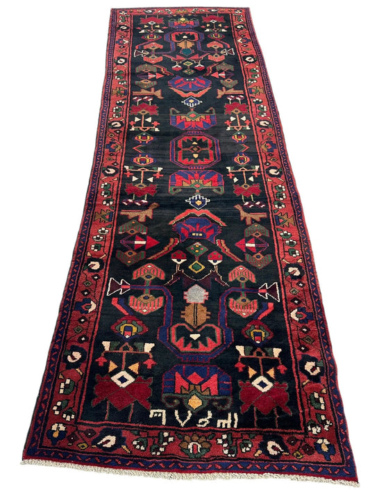 Handknotted Hamadan Runner Rug with tribal motifs in red and blue on dark field with red border on Tampa Home & Garden Store