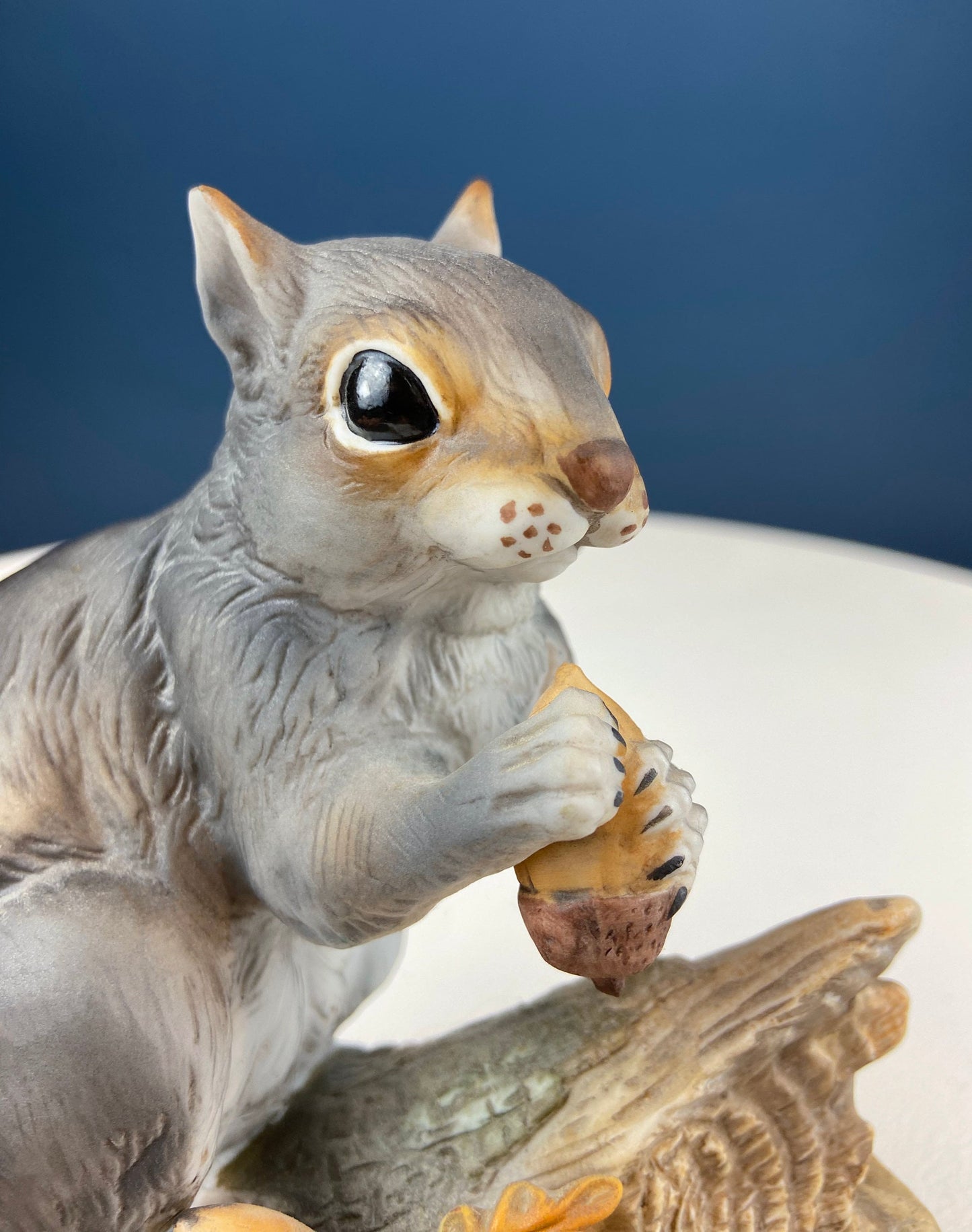 Hand painted sweetheart chipmunk figurine, gray porcelain, holding acorn on branch on Tampa Home & Garden Store