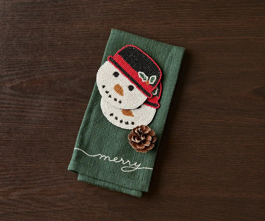 Snowman beaded coaster on green linen fabric with pinecone accent Payton James on Tampa Home & Garden Store
