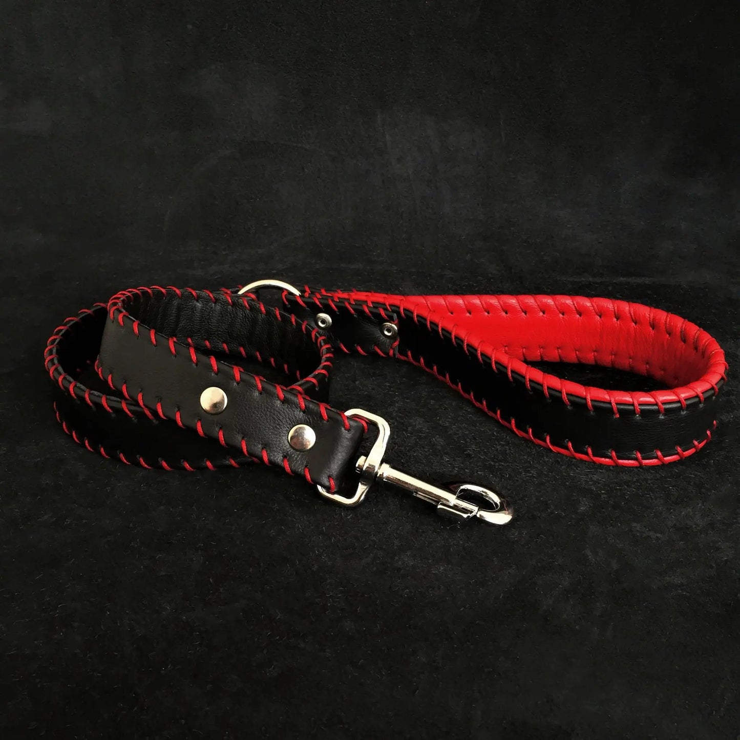 Two handstitched leather leashes with padded handles black and red braided edges metal hardware on Tampa Home & Garden Store