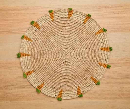 Handwoven Carrot Round Raffia Placemat with orange stripes and green tassels on Tampa Home & Garden Store