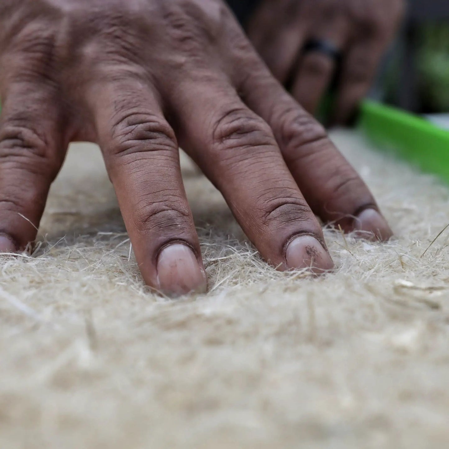 Hemp Grow Mats for 1020 Microgreens Trays, natural tan hemp fiber, hands pressing into soil on Tampa Home & Garden Store