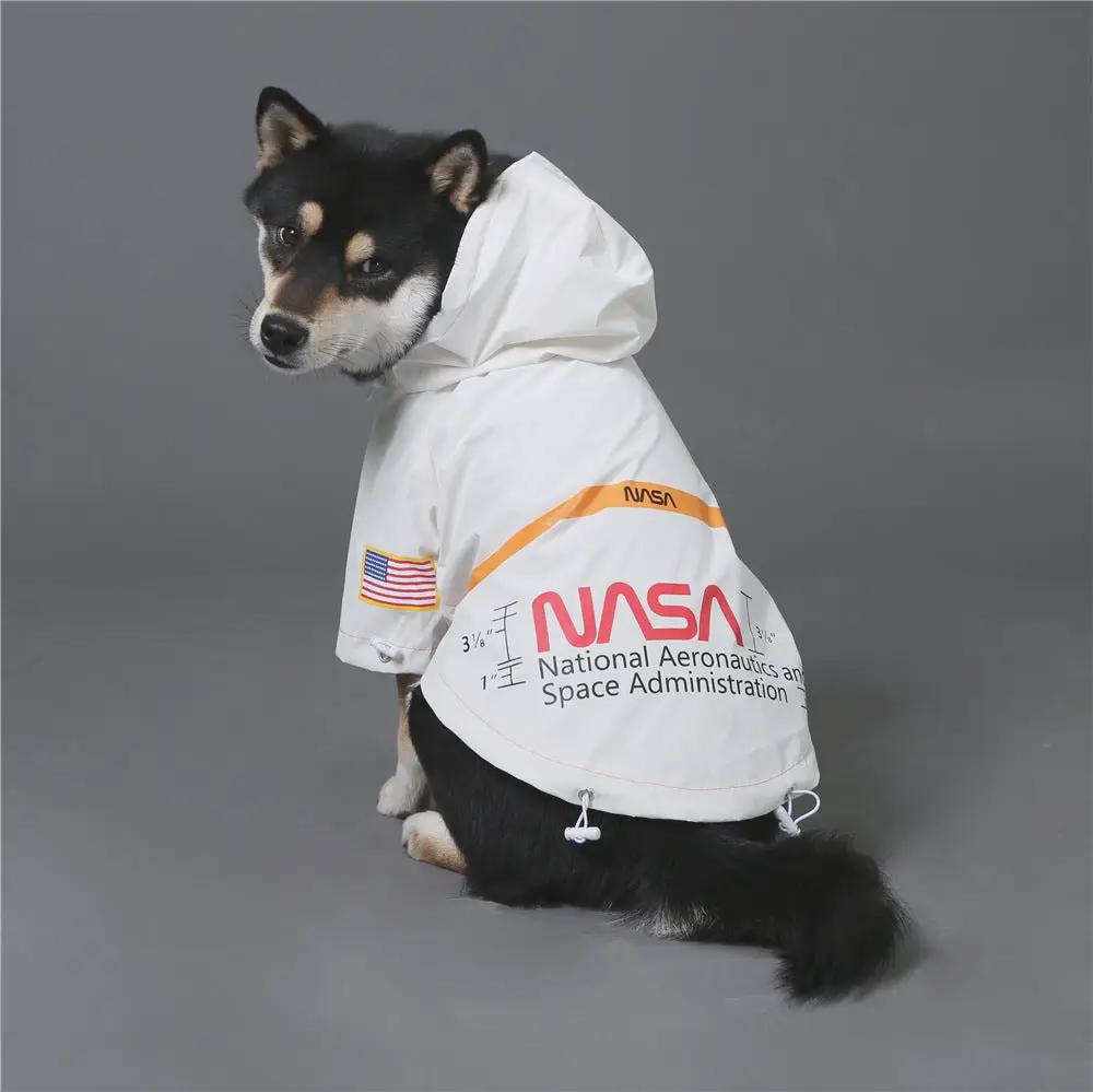 Dog raincoat jacket in white with NASA logo, orange stripe, and US flag patch on Tampa Home & Garden Store