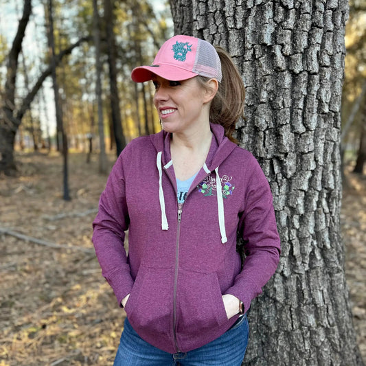 Highland Coo embroidered hat, pink front panel with teal cow logo and gray mesh back on Tampa Home & Garden Store
