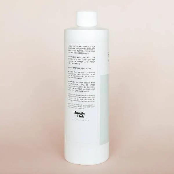 House Plant Fertilizer bottle cylindrical container with white cap Jungle Club label on Tampa Home & Garden Store
