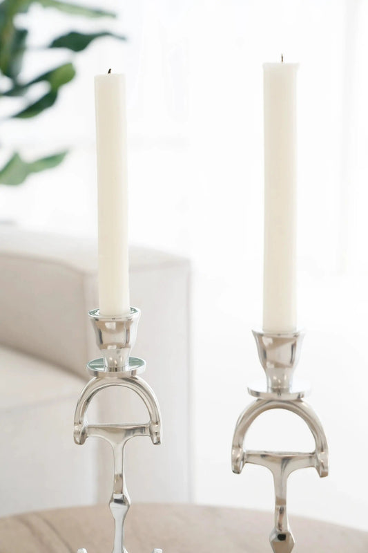 Huntley D Bit Candlesticks in aluminum finish, pair with white taper candles on silver holders on Tampa Home & Garden Store