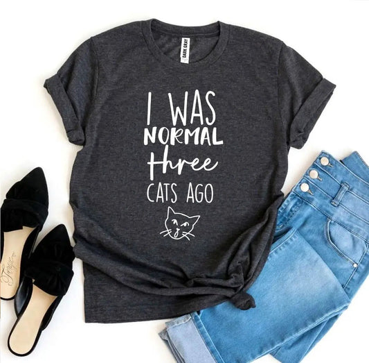 I Was Normal Three Cats Ago T shirt, dark gray premium tee with white handwritten text and cat illustration on Tampa Home & Garden Store