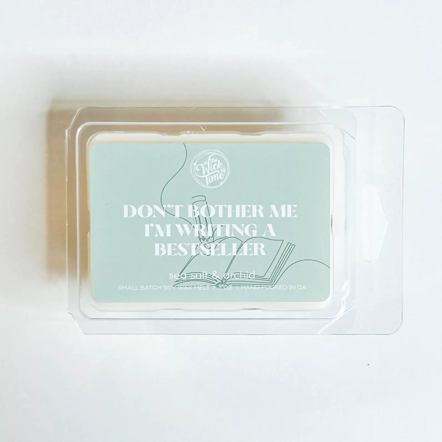 Wax melt clamshell blue label Don't Bother Me I'm Writing a Bestseller; In the Wick of Time logo on Tampa Home & Garden Store