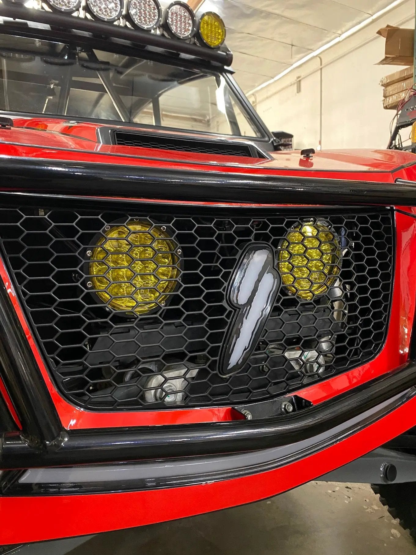 Speed UTV Behind the Grill LED Light Mount by GGLighting on red front with yellow LEDs on Tampa Home & Garden Store