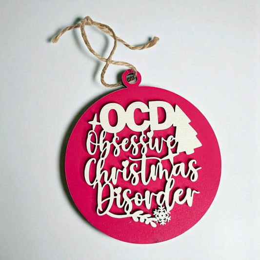 Obsessive Christmas Disorder ornament pink laser-cut script and tree motif jute hanger on Tampa Home & Garden Store