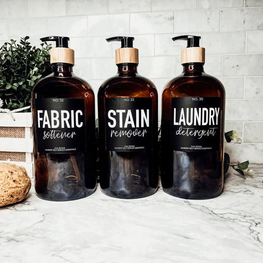 Three Gia Roma 32oz amber glass soap dispensers with black labels for laundry essentials on Tampa Home & Garden Store