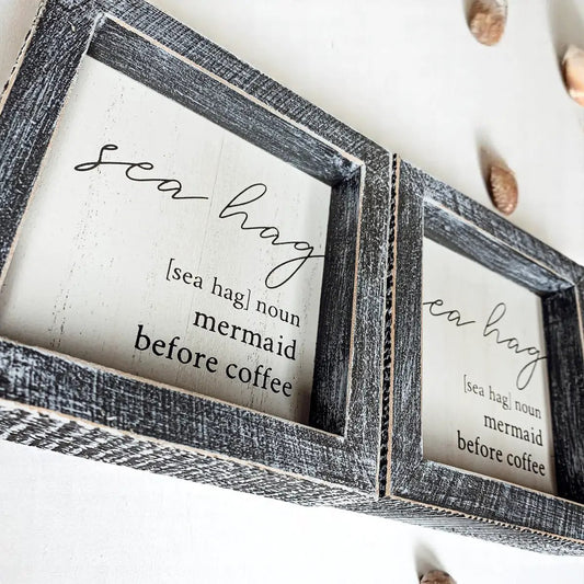Sea Hag Sign wall art set of two in distressed black wood frames with mermaid before coffee on Tampa Home & Garden Store
