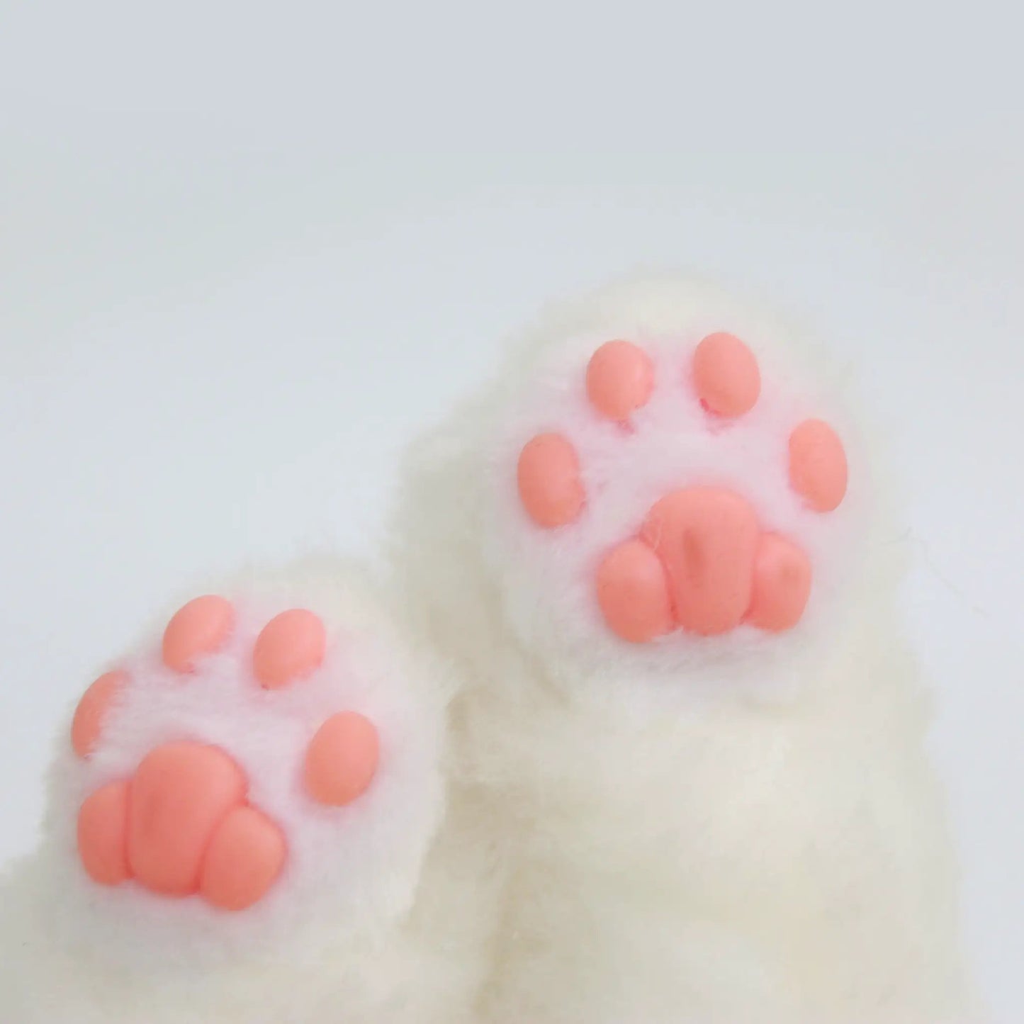 Custom plush cat paw with pink paw pads on white fluffy fur on Tampa Home & Garden Store