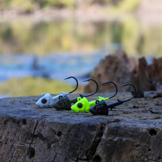 Reaction Tackle lead fish head jigs 5-pack neon lime and white fishing lures on a wooden stump on Tampa Home & Garden Store