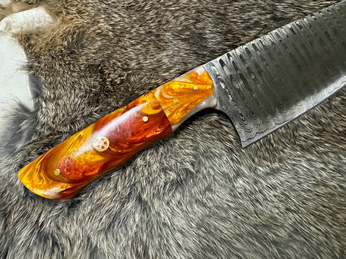 Damascus steel chef knife TK-104 with orange resin handle and brass rivets, patterned blade on Tampa Home & Garden Store