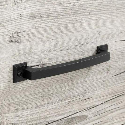 Black metal dresser drawer pull with square backplates on weathered wood surface on Tampa Home & Garden Store
