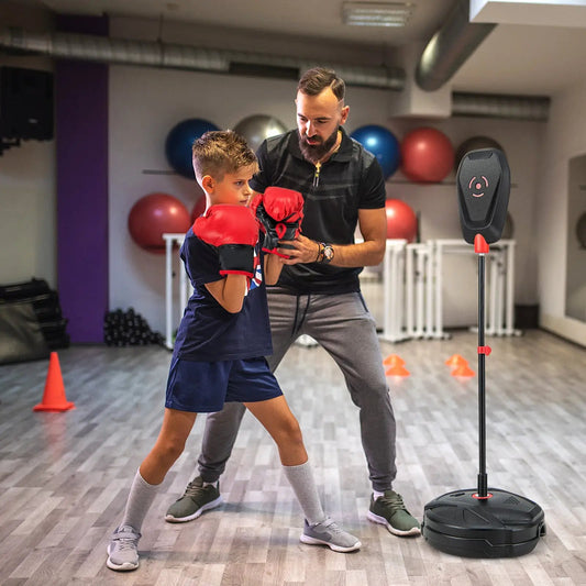 Inflation-Free boxing set with punching bag stand and red gloves; trainer coaching child on Tampa Home & Garden Store