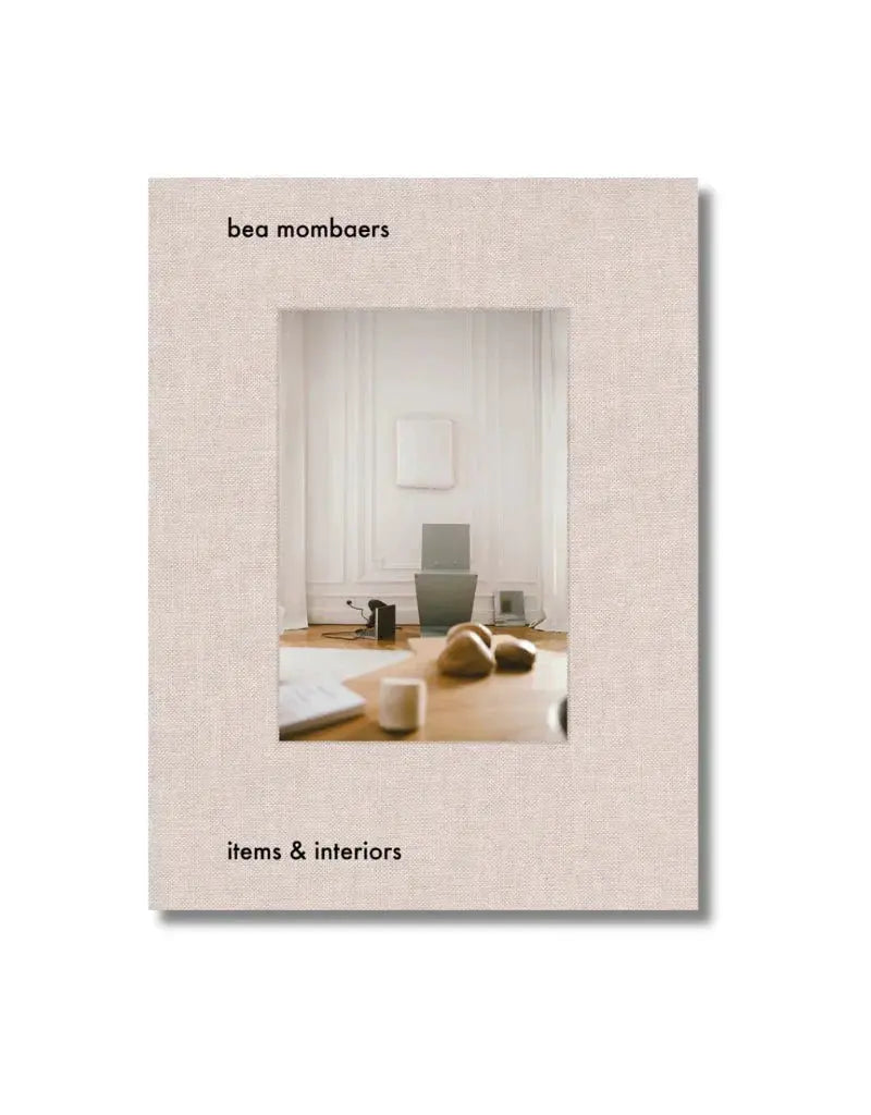 Items and Interiors book with beige linen cover and central room photo by White Cliff Studio on Tampa Home & Garden Store