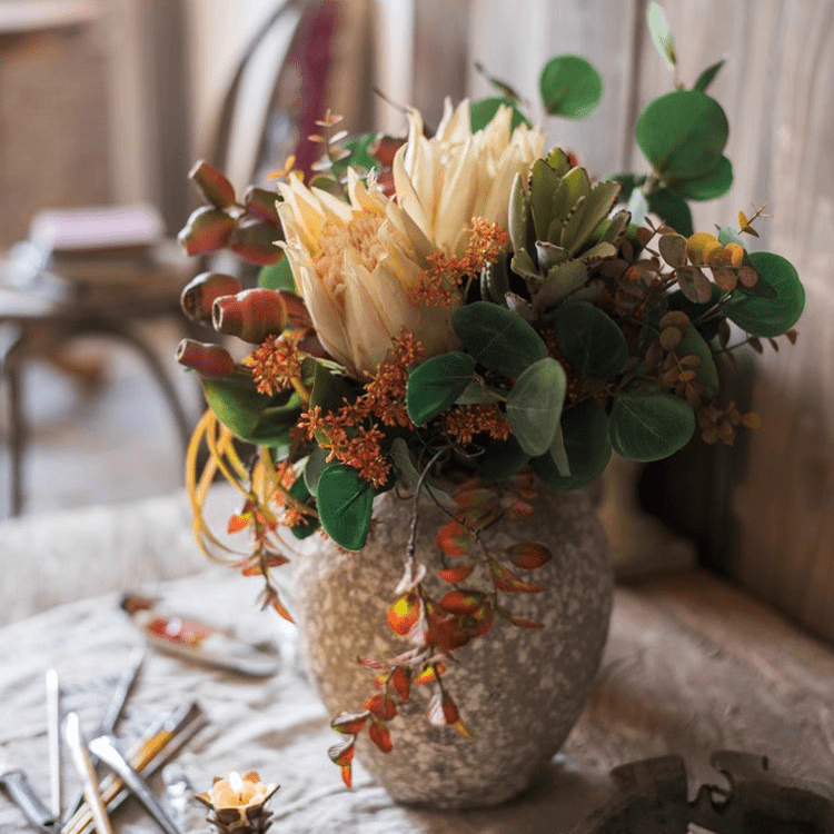 Mountian Oriole Autumn Art King Protea Bouquet in a textured stone vase with eucalyptus on Tampa Home & Garden Store
