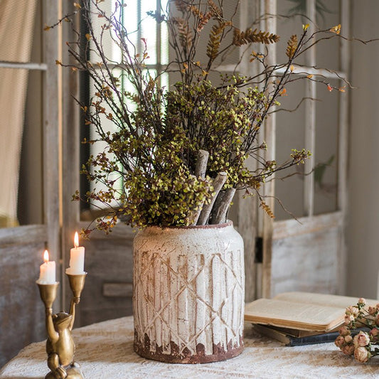 Distressed white ceramic flower jar vase with carved pattern, filled with dried branches on Tampa Home & Garden Store