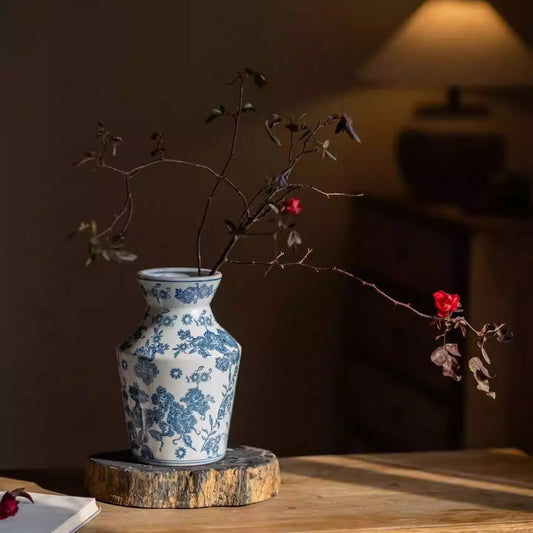 Indigo porcelain vase with blue floral pattern on a wooden pedestal on Tampa Home & Garden Store