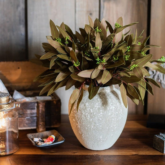 Artificial oval-leaf eucalyptus stem bundle in brown, 18 inches tall, arranged in a textured white vase on Tampa Home & Garden Store
