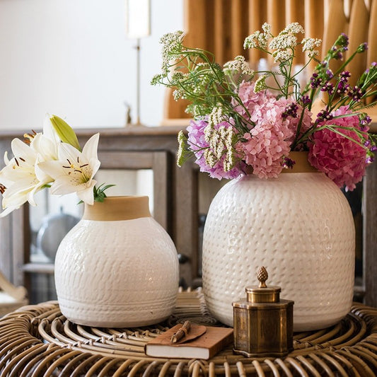 White glazed ceramic flower vases set with textured surface and pink hydrangeas on a wicker table on Tampa Home & Garden Store