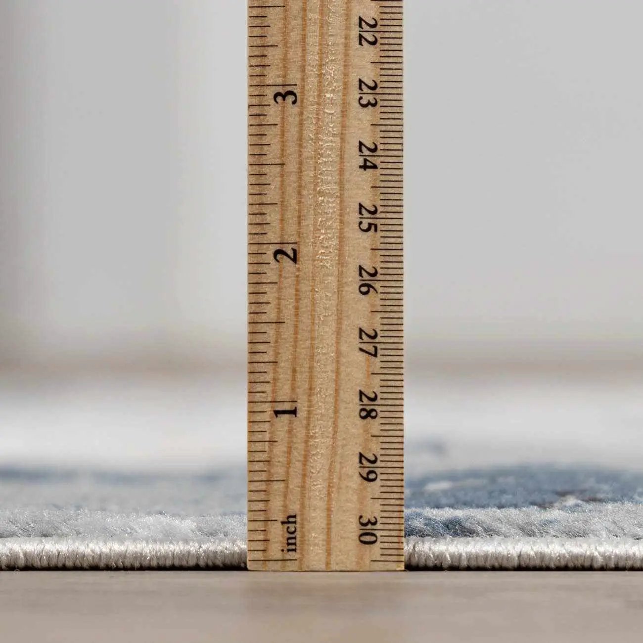 Kirkland Dark Blue Marble Rug; rug edge with a ruler for scale on Tampa Home & Garden Store
