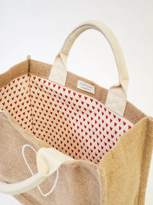 Jute canvas tote bag by KORISSA with red heart lining and natural handles on Tampa Home & Garden Store