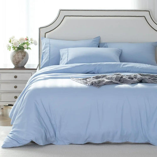 Kasentex light blue duvet cover set with pillowcases on a white bed with tufted headboard on Tampa Home & Garden Store