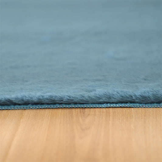 Kasentex Fluffy Faux Fur Area Rug Ultra Soft blue faux fur with edge seam on wood floor on Tampa Home & Garden Store