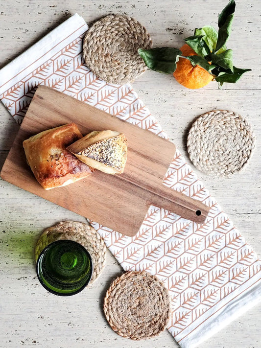 Kata Natural Drink Coasters set of 4, round woven jute on rustic wood table on Tampa Home & Garden Store