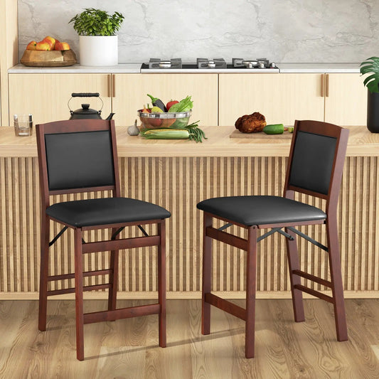Two folding kitchen island stools with rubber wood frames and black padded seats on Tampa Home & Garden Store