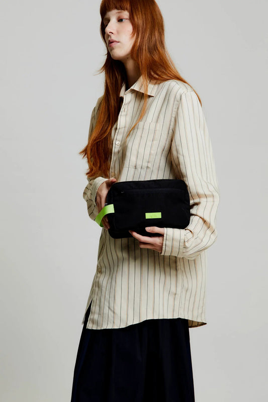 Kei Double Washbag Black Lime Vandra by Lefrik with neon strap held by model on Tampa Home & Garden Store