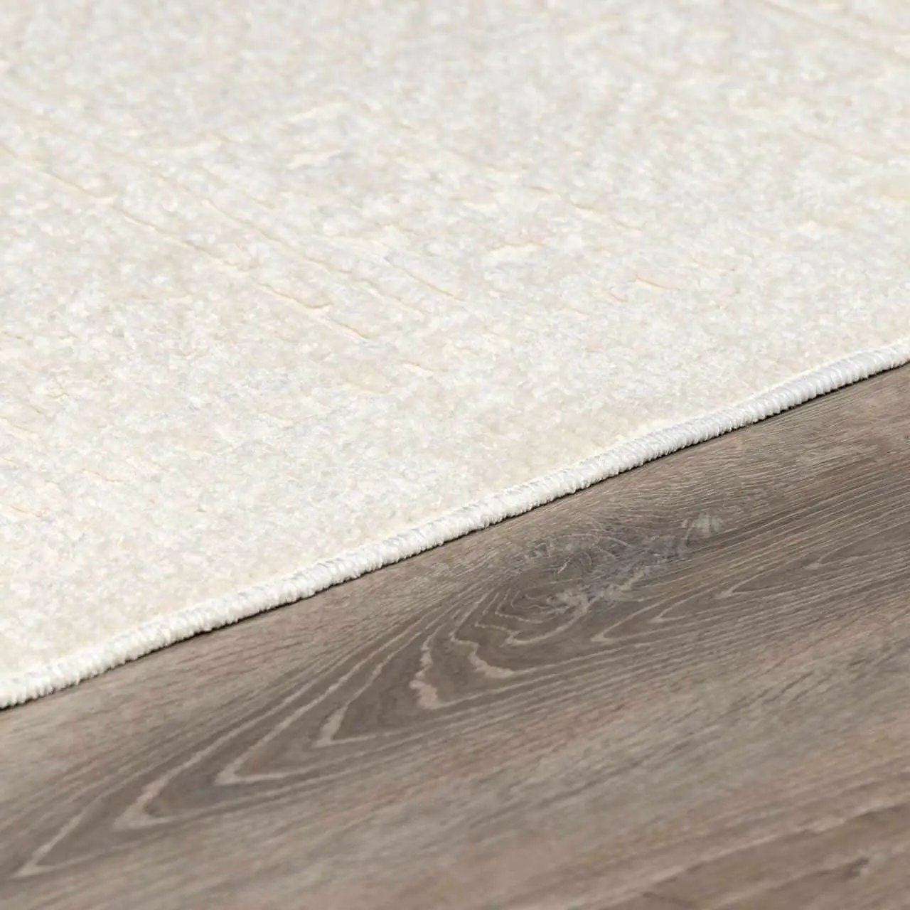Bahar Cream Washable Area Rug by Boutique Rugs in cream with white fringe edge on wood floor on Tampa Home & Garden Store